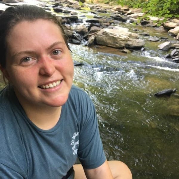 Laura, smiling in front of some rushing water