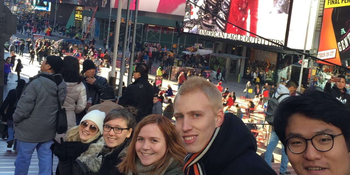 Anna and friends smiling at the camera in Times Square