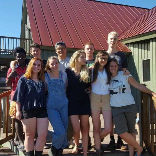 Anna and a group of volunteers gathered together and smiling at the camera